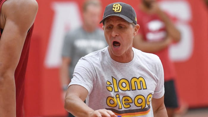 Arkansas coach Eric Musselman, wearing his San Diego Padres' gear, yells instructions at Wednesday's practice as the Razorbacks get ready for European exhibition games.